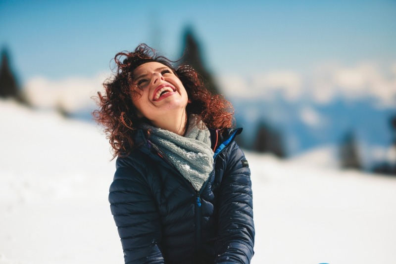 Leavenworth Washington Winter: A young woman smiles amid a beautiful winter landscape in Leavenworth, WA.