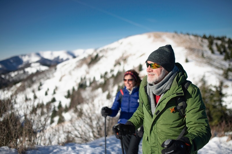 Leavenworth Washington Winter: A senior couple joyful trek along a mountain ridge near Leavenworth, WA.